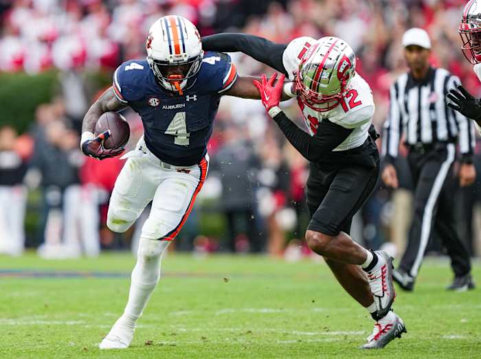 Tank Bigsby (4) stiff arms defender during the game between Auburn and Western Kentucky at Jordan-Hare Stadium. Austin Perrymann/AU Athletics